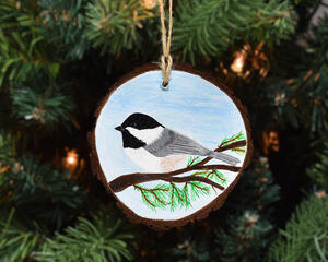 A hand-painted backyard bird wood slice ornament available at Cove Creek Photography.